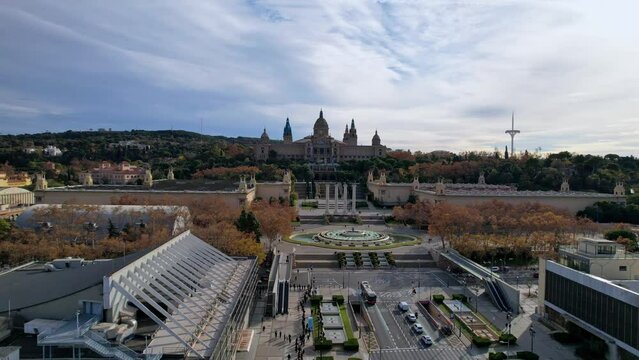 Aerial long view of Avinguda de la Reina Maria Cristina at its junction with Montjuic Palace in background. This iconic square is located at foot of Montjuic major landmark in Barcelona. 4K video