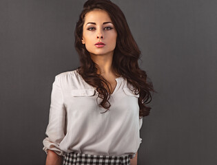 Beautiful natural makeup  woman with long brown healthy wavy hair style in casual clothing in white blouse.  Closeup portrait