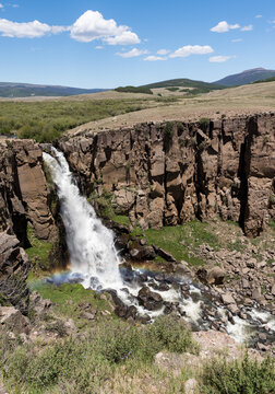 A Rainbow occurs from the spray of North Clear Creek Falls. The falls drop 100 feet into the canyon and can be viewed from a side road along the Silver Thread Scenic Byway. 
