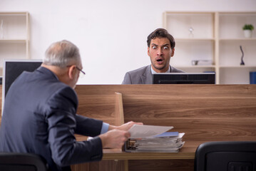 Two male colleagues working in the office