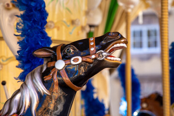 black horse s head on an amusement park carousel in Lucca, Italy