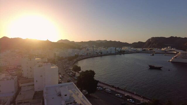 Muscat, Oman: Panoramic view of the Mutrah old town and corniche by the Indian ocean in Muscat, Oman capital city at sunset. 