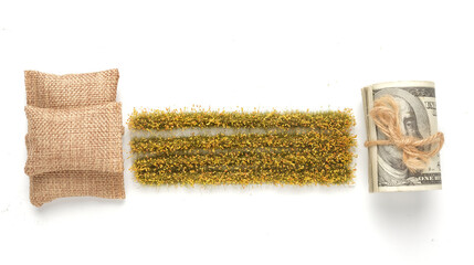 A picture of miniature rice paddy field, fake money and rice bags on white background