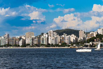 Fototapeta premium Guanabara Bay in Rio de Janeiro, Brazil with a hill in the background. Beautiful landscape and hill with the sea. Sailing boats in the bay. Icaraí beach, Niterói in the background