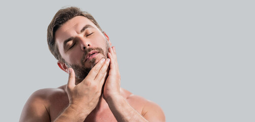 Fototapeta premium Close up portrait of handsome man. Portrait of shirtless man for skincare and beauty concepts. Man with beauty face, facial skin portrait. Male healthy skin and spa concept. Banner for header.