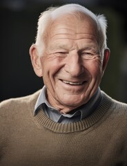 Portrait of a happy senior man with white hair smiling at the camera
