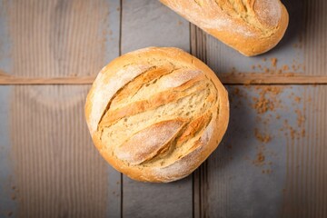 bread on table, two freshly baked loaves, freshly baked bread on a wooden table