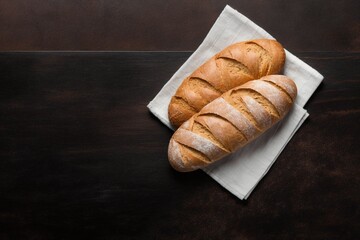 fresh baked bread, two freshly baked loaves, freshly baked bread on a wooden table