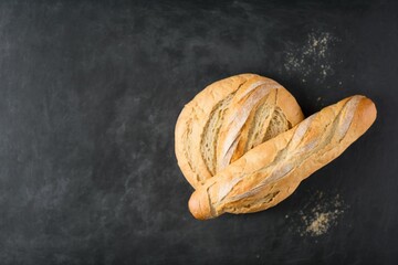 two freshly baked loaves, freshly baked bread on a stone table