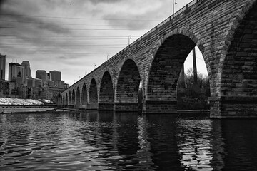 Arch bridge in Minneapolis.   Picture in black and white.