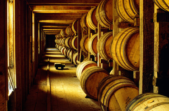 Whiskey whisky bourbon maturing in barrels in old store warehouse at the distillery, Tennessee, USA