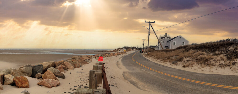 Sunlight through the storm clouds over roadway along Chapin Beach