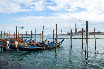 Fototapeta na wymiar Gondolas in San Marco basin, view at San Giorgio Maggiore island. Venice, Italy.