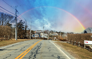 Rainbow over town center of Chatham on Main Street on a sunny day in winter