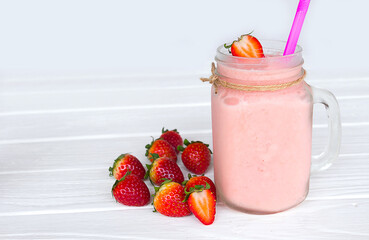 Strawberry yogurt fruit juice smoothie pink colorful fruit juice milkshake blend beverage healthy high protein the taste yummy In glass drink episode morning on white wood background.