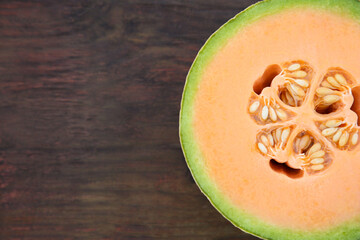 Half of fresh ripe melon on wooden table, top view. Space for text - obrazy, fototapety, plakaty
