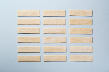 Many sticks of tasty chewing gum on light grey background, flat lay