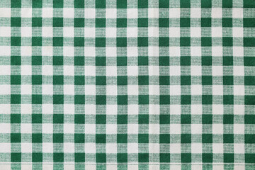 Green checkered tablecloth as background, top view
