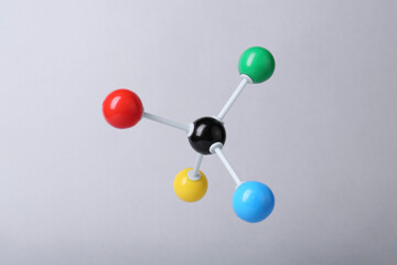Molecular atom model on light grey background. Chemical structure
