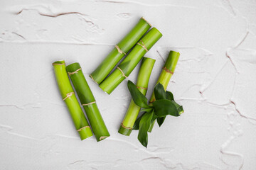 Pieces of beautiful green bamboo stems on white textured background, flat lay © New Africa
