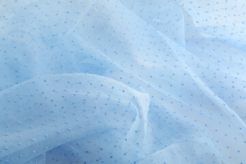 Beautiful light blue tulle fabric as background, closeup