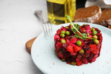 Delicious vinaigrette salad on white textured table, closeup. Space for text