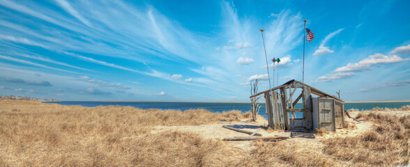 Fluffy clouds and blue sky over the Occupy Chatham public shack on Chatham South Beach