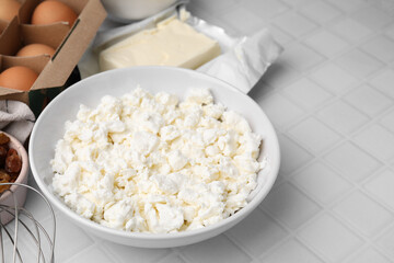 Different ingredients on white tiled table, space for text. Cooking cottage cheese pancakes