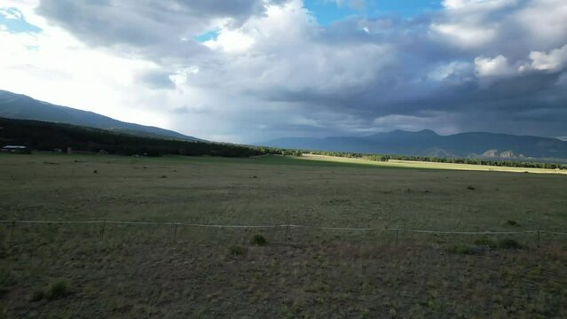 Sunset fly over the plains of Buena Vista, Colorado, near the Rocky Mountain National Park. Aerial 4K drone video