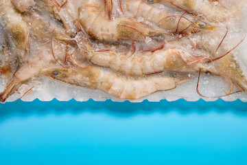 top view frozen prawns on blue with copy space horizontal composition