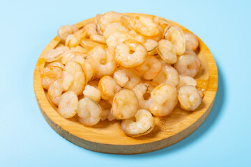 angle view fresh cooked unskin shrimps on blue background horizontal composition
