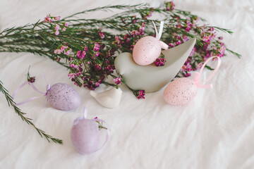 Easter eggs with flowers on white linen fabric. Spring and Easter concept.