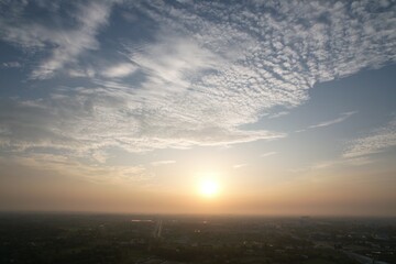 Beautiful evening landscape photograph of a rural town with waves clouds and sunset, Sky background.