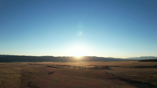 Sunrise fly over the plains of Buena Vista, Colorado, near the Rocky Mountain National Park. Aerial 4K drone video