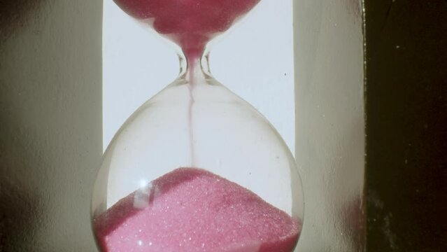Time concept, Extreme Close-Up,hourglass with pink sand