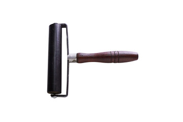 An old rubber roller with scratches that have been used isolated on white background. Equipment for handcraft.
