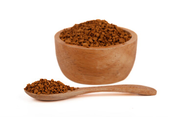 Instant coffee on wooden spoon and bowl isolated on white background. Instant coffee is a beverage derived from brewed coffee beans that enables people to quickly prepare hot coffee.