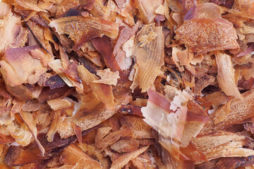 Flat lay of Dried Bonito Flakes (Katsuobushi). Katsuobushi is made from bonito flakes that have been smoked and hard dried, To be shavings into a thin sheet for Japanese soup stock.