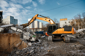 Hydraulic excavator works with debris at demolition site