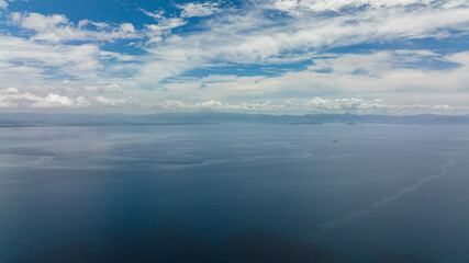 View of Negros Island from the sea. Water cloud horizon background.