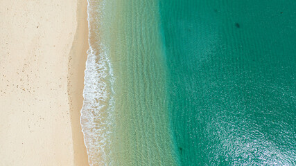 Top view of Sandy beach and sea surf with waves. Pagudpud, Ilocos Norte Philippines