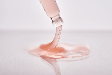 Pipette with a viscous pink cosmetic close-up.