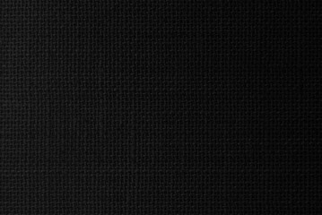 Black hemp rope texture background. Haircloth wale black dark cloth wallpaper. Rustic sackcloth canvas fabric texture in natural.
