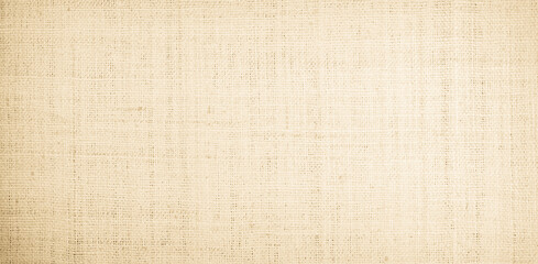 Fototapeta premium Jute hessian sackcloth burlap canvas woven texture background pattern in light beige cream brown color design element. 