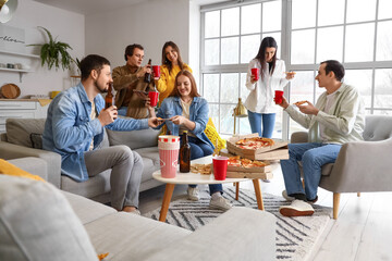 Group of friends with tasty pizza and drinks at home