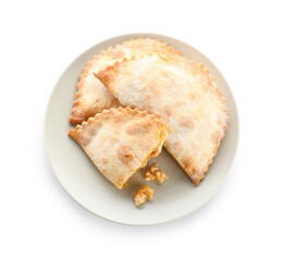 Plate with baked meat empanadas on white background