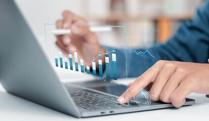 Businessman analyzing growth sales data graph on modern interface icons. digital online marketing Financial and investment business planning and development.