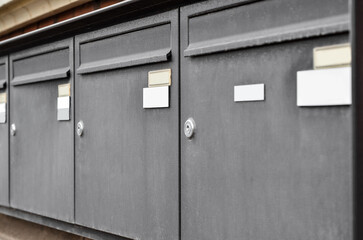 Obraz na płótnie Canvas View of mailboxes on building wall, closeup