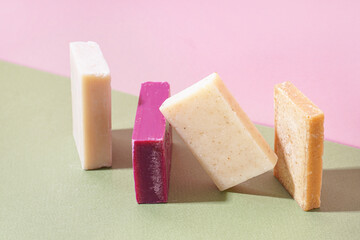 Set of natural soap bars on color background