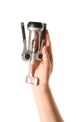 Naklejka premium Female hand holding wine opener isolated on white background